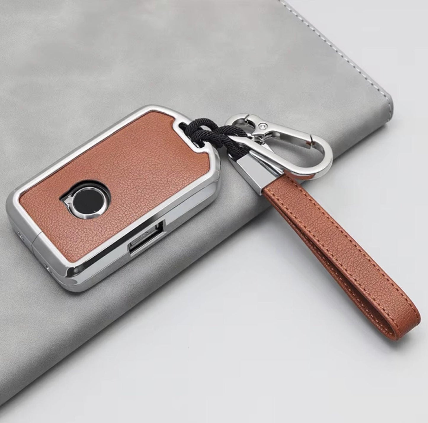 Volvo and Polestar key fob cover set by Kollen US featuring leather and aluminum materials, displayed on a white background.