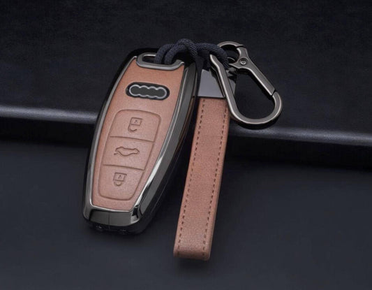 Customizable leather and aluminum Audi key fob cover with keychain by Mestiere Coriaceo, showing a sleek, stylish accessory for car keys.