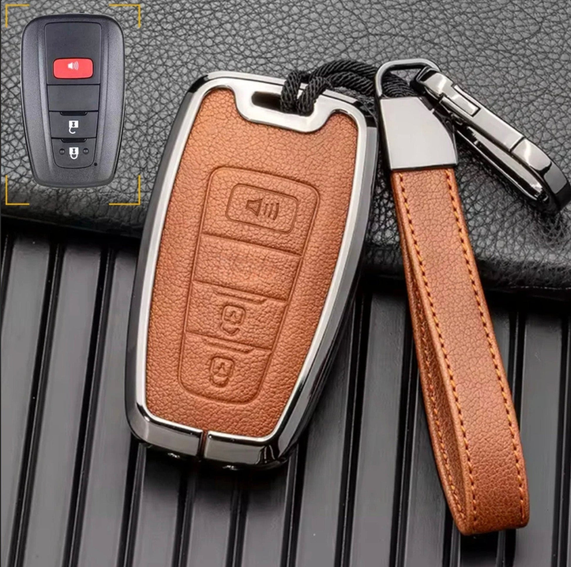 Brown leather and chrome Toyota key fob cover with aluminum accents and keychain, customizable for 3-button Toyota models.