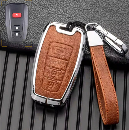 Customizable brown leather and chrome aluminum Toyota key fob cover with keychain for 3-button keychains by Mestiere Coriaceo.